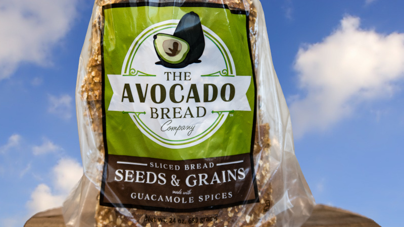 Closeup image of a loaf of The Avocado Bread Company's SEEDS & GRAINS with Guacamole Spices bread.