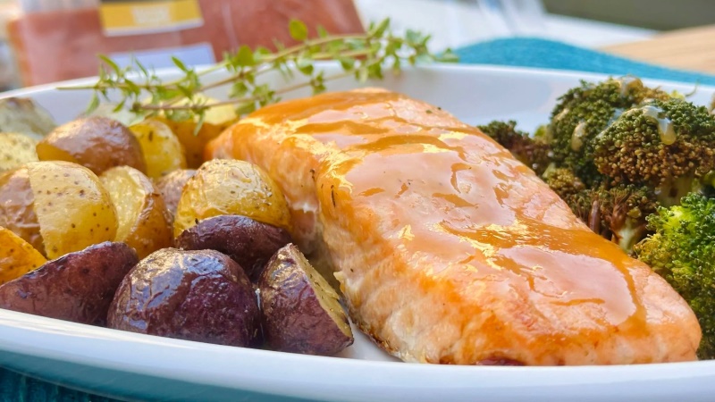 Salmon with a honey coating, potatoes, and broccoli.