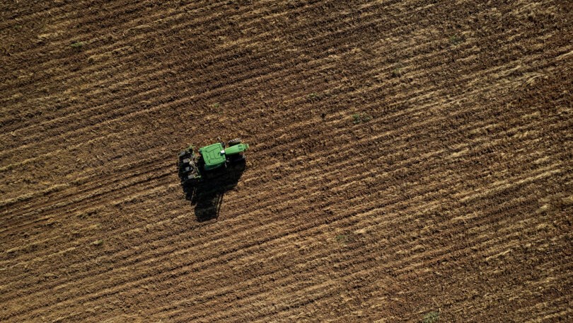 Drone view of tractor in a field. 