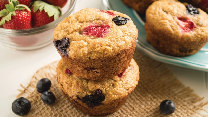 Plated mixed berry whole-wheat muffins. 