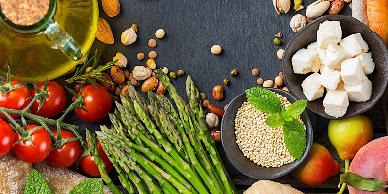 Table top of assorted foods associated with a Mediterranean diet. 