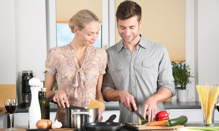 Couple cooking together at home. 