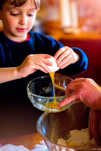 Kid cracking open an egg. 