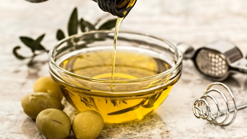 Glass bowl of olive oil.