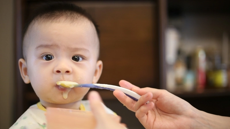 Baby being spoon fed.