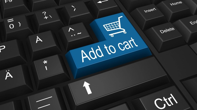 Keyboard with enter key that has image of shopping cart and words 'Add to cart'.