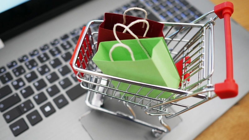 Shopping cart on top of a laptop keyboard. 