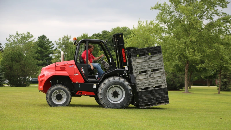 M 30-4 AG Forklift doing a demo with bins in field.