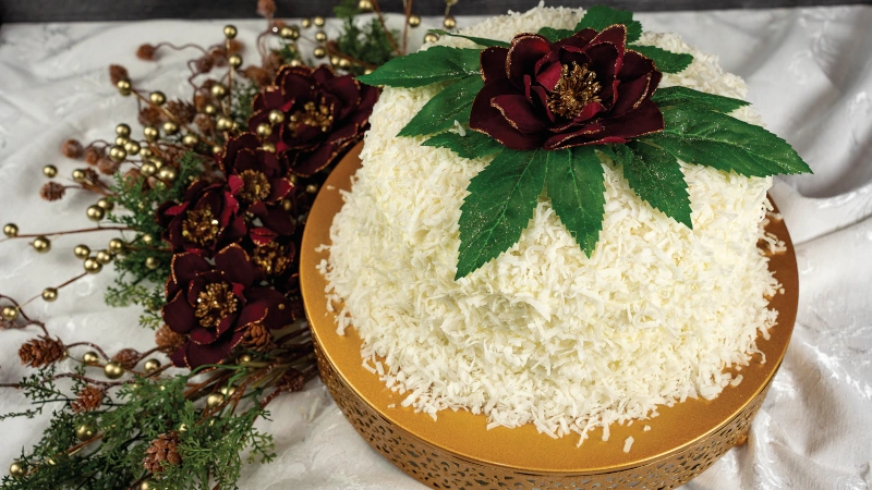 Elegant Coconut Cake on a holiday themed table.