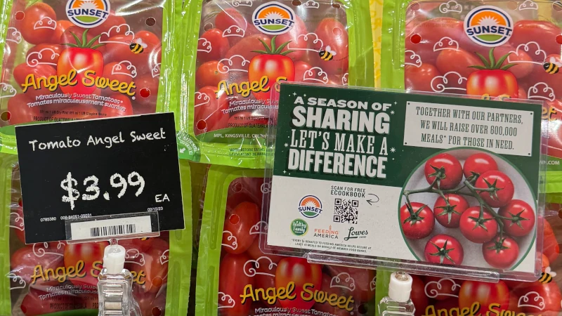 Season of Sharing campaign card on display with tomatoes.