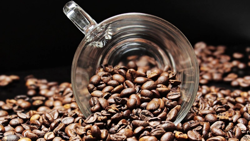 Coffee beans in a glass mug.