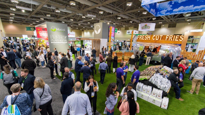 View of CPMA trade show floor with people and exhibitors. 