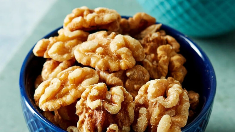 MAcro image of a small bowl of walnuts.