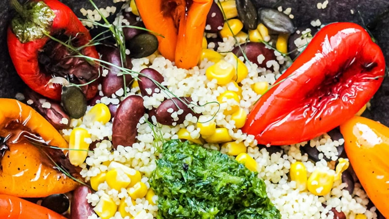 Bowl of roasted peppers, red lima beans, spinach and quinoa.