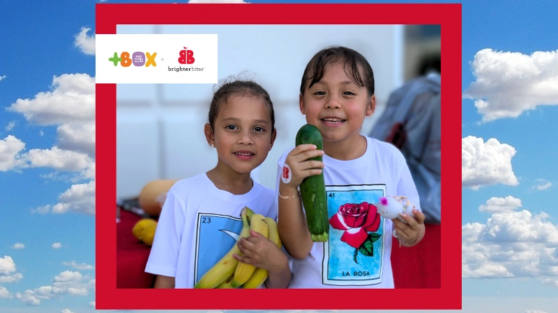 Two kids eating fresh produce.