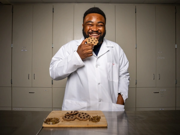 Lab member enjoying upcycled chocolate chip cookie.