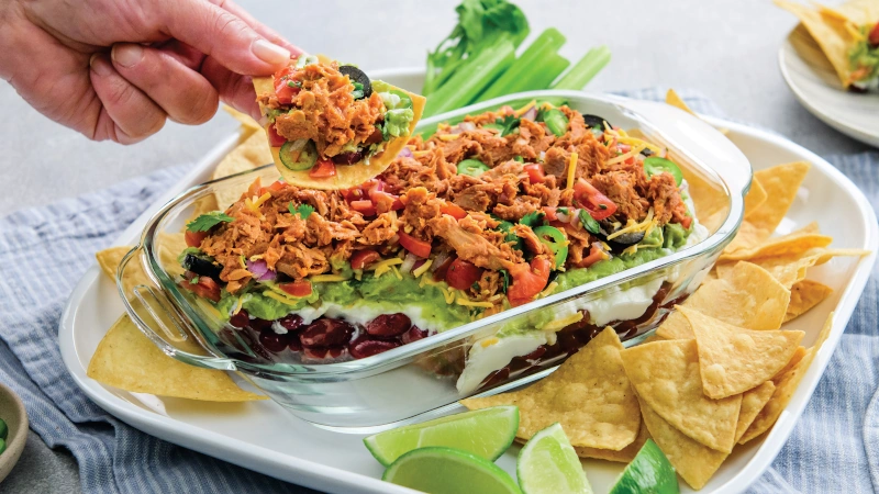 7-Layer Chili Lime Tuna dip in glass dish.