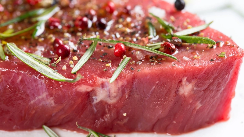Raw steak seasoned ready for the grill