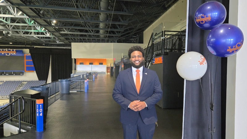 Yousif Omer standing on upper level of Trojan sports arena.
