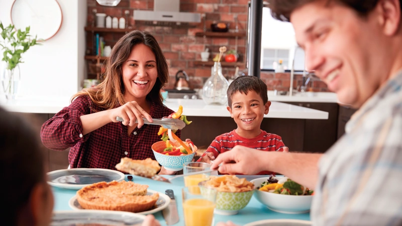 Family of four eating dinner.