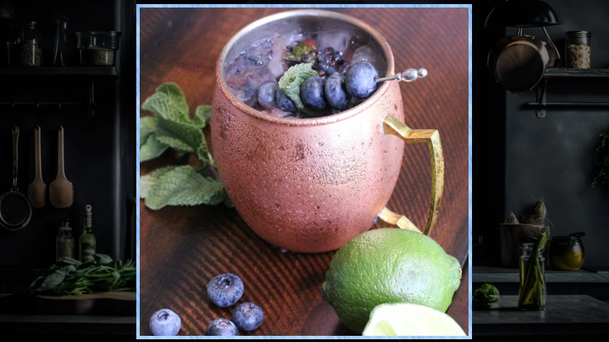 Blueberry Mule with limes and berries around the mug.
