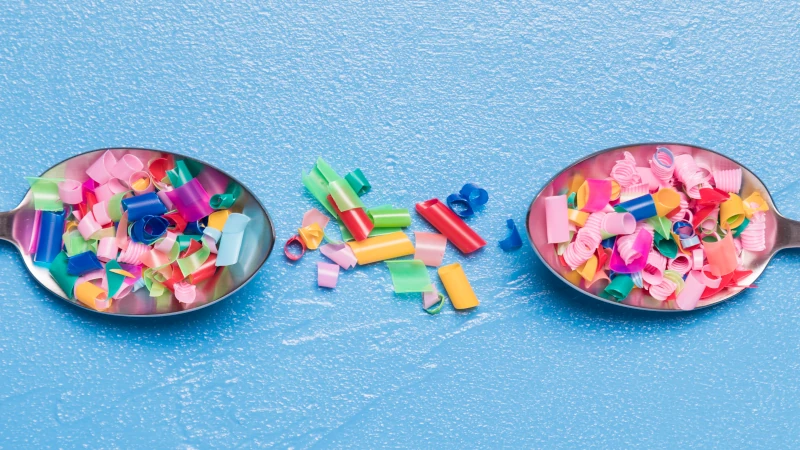 Spoons with small plastic pieces on them.