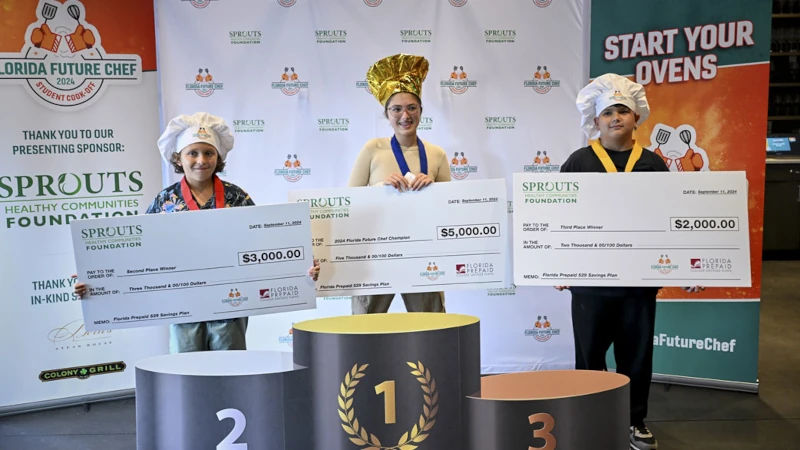 3 kid chefs holding prize checks.