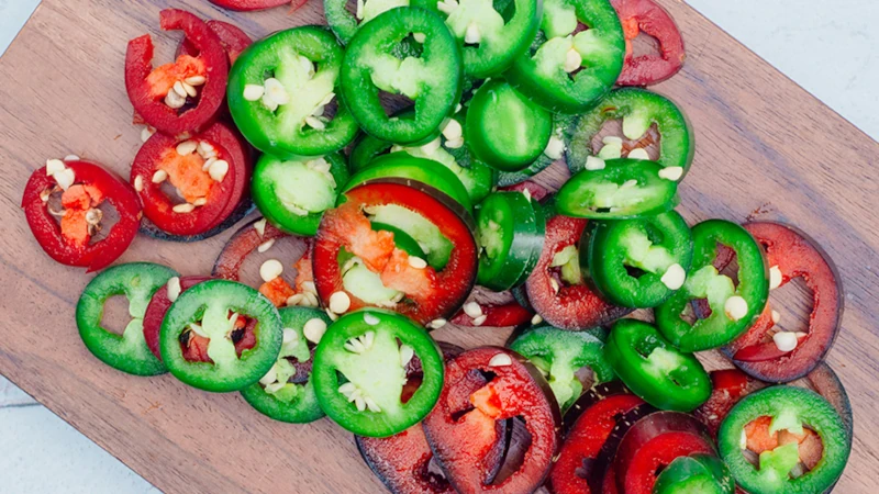 Sliced jalapeno rings on a cutting board