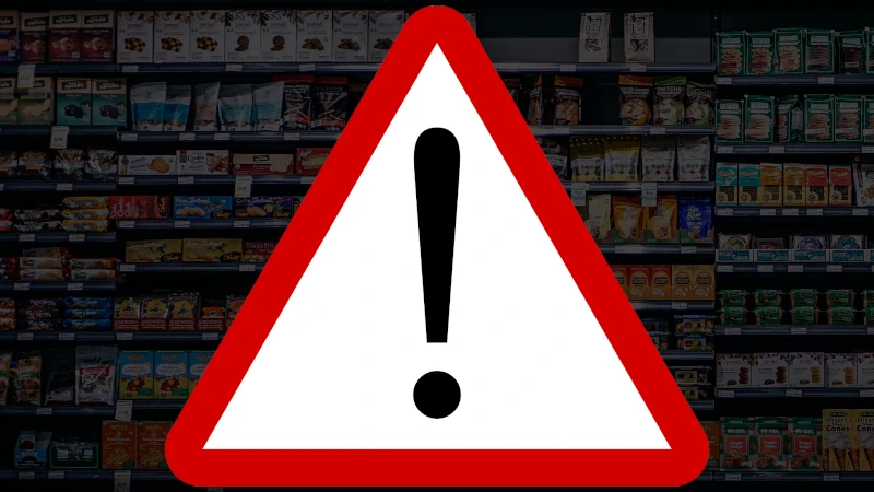 Processed food grocery aisle with a warning sign overlay