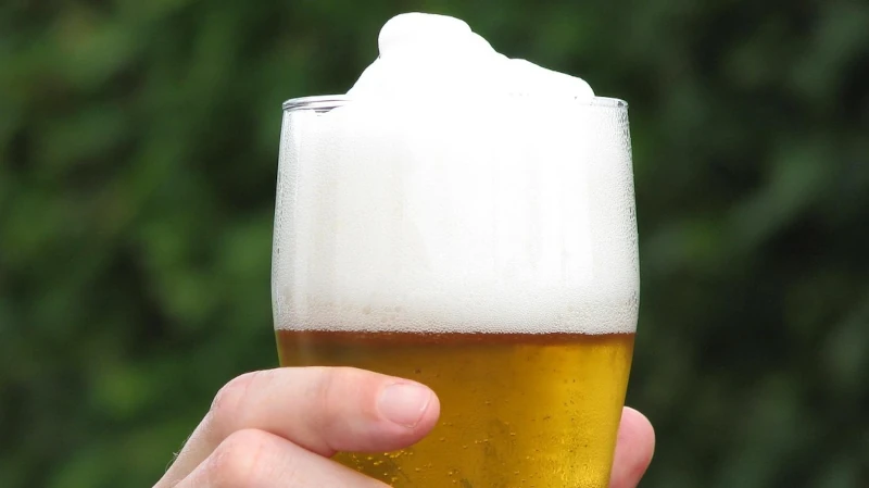 Glass of beer with thick foam head