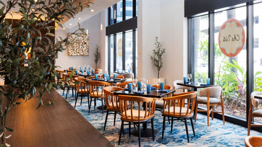 Che Vita's main dining room with tables by the windows.