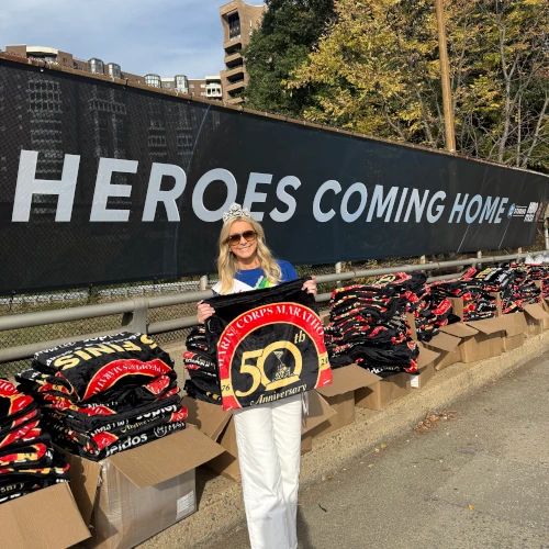 Watermelon Queen holding marathon shirts