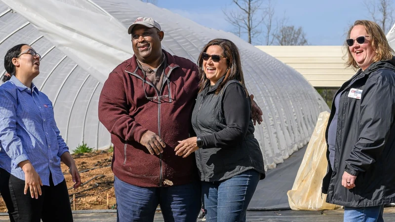 Four people on a farm.