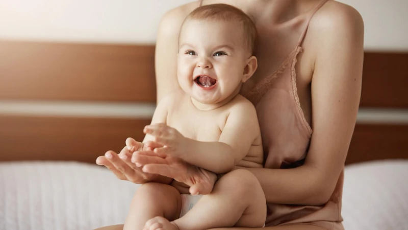 Smiling baby on Mom's lap.