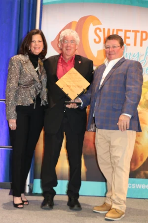Man accepting award on stage. 