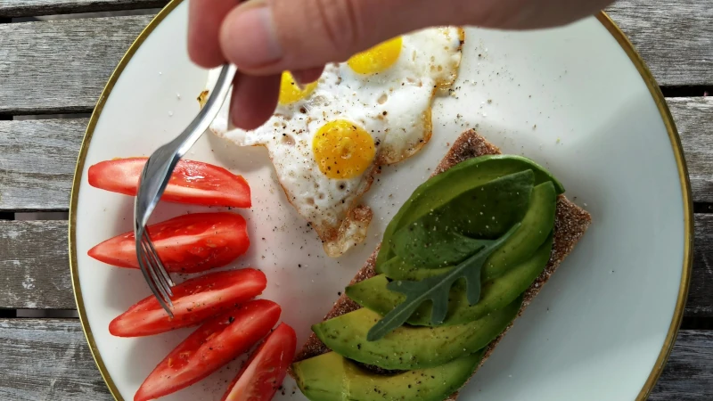Avocado toast, eggs and tomatoes.