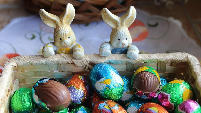 Bunnies looking at a basket of Cadbury eggs