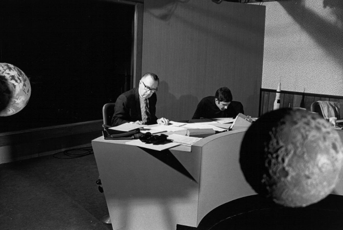 Walter Cronkite at a desk. 