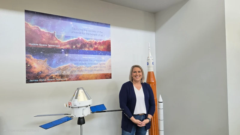 Woman in front of poster. 