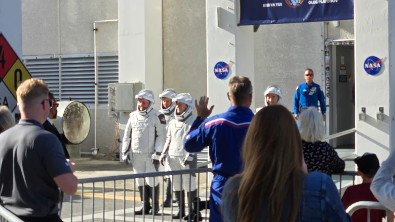 Crew of four leaving building. 