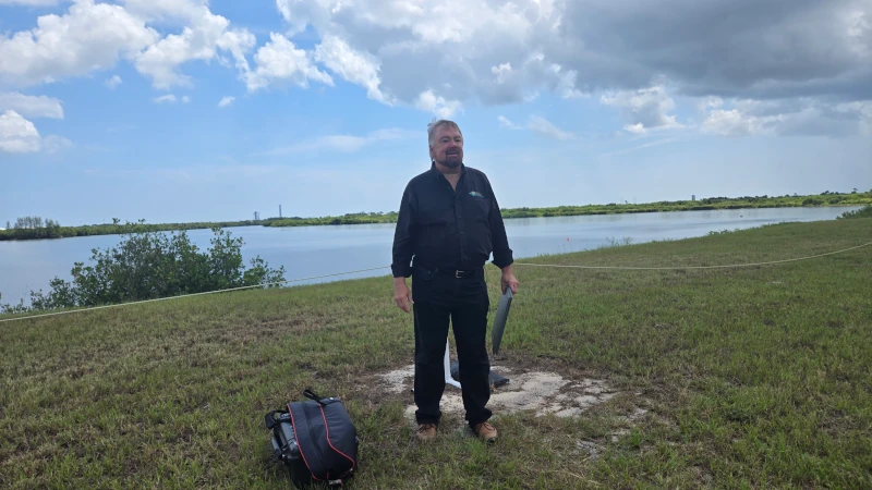 Man standing in viewing area for rocket launch. 