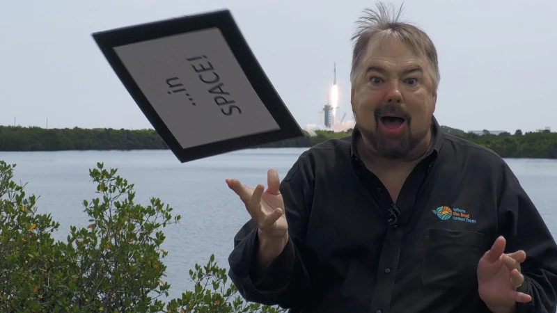 Man in front of rocket. 