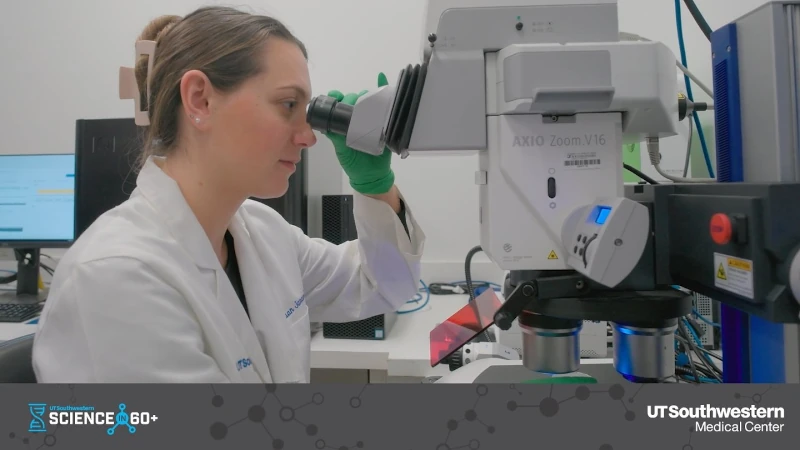 Woman looking through a microscope