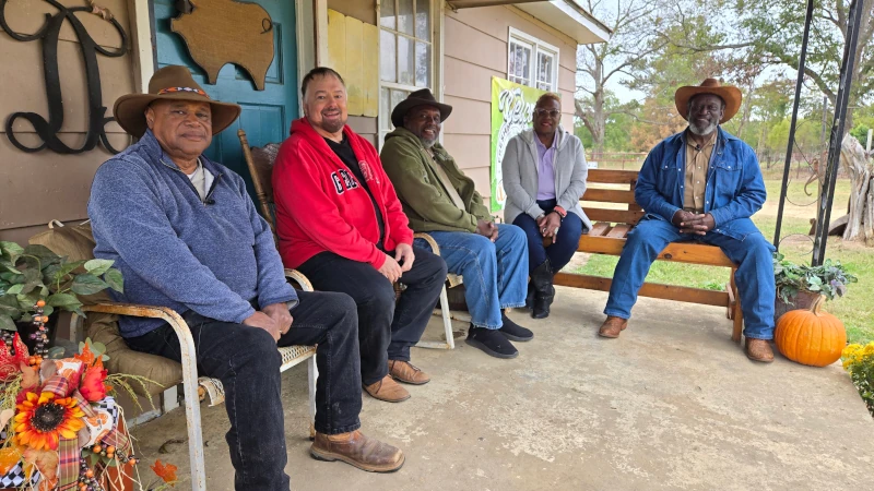 Group of men sitting on a front porch.