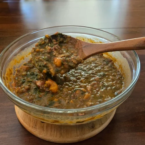 Bowl of lentil soup with spinach.