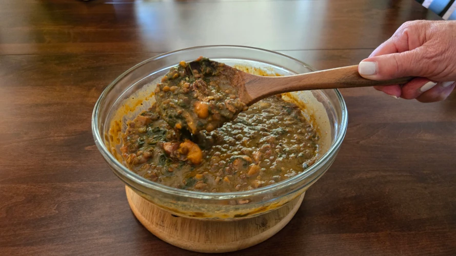 Bowl of lentil soup with spinach.