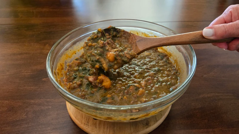 Bowl of lentil soup with spinach.