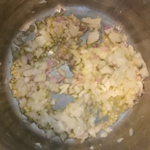 Aromatics sautéing in pot.