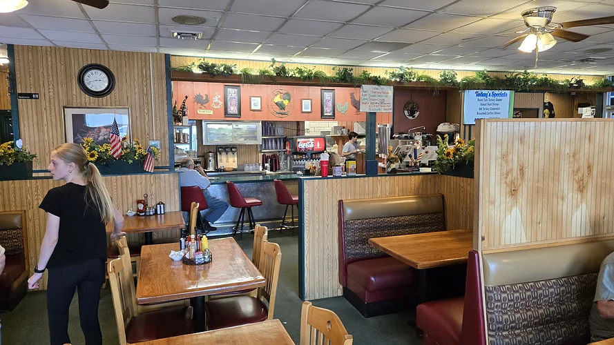 Johnnie Mars dining room with wood-paneled booths, tables and a lunch counter with red stools.